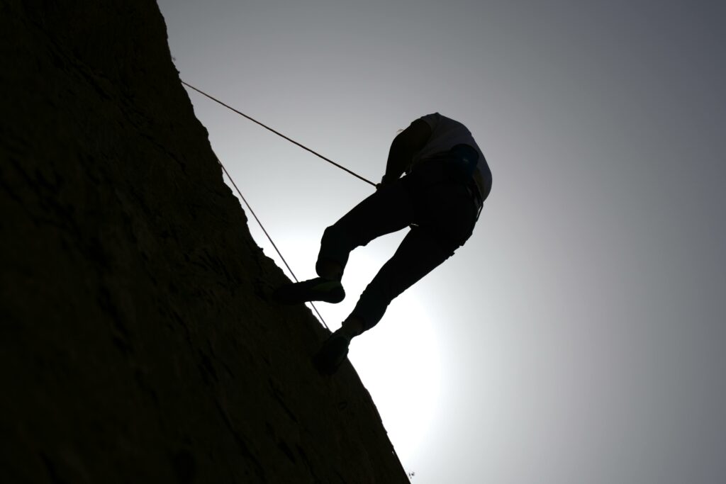 A silhouette of a rock climber against the sky in Damascus, Syria.